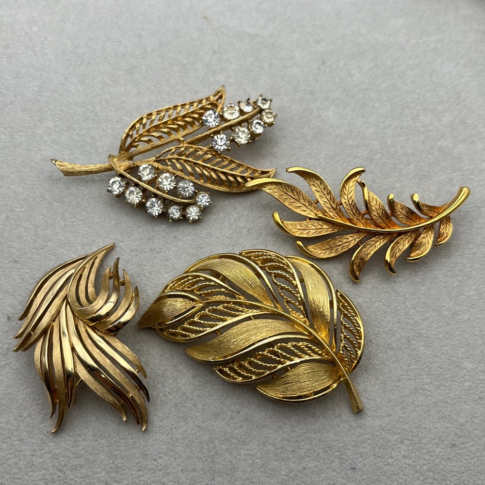 4 signed gold tone leaf brooches, Coro, JJ, Lisner and Trafari.